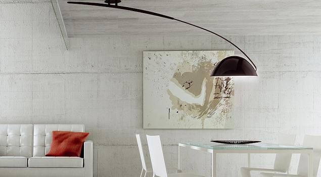 Lampy sufitowe i beton w salonie z jadalnią. Minimalistyczny salon